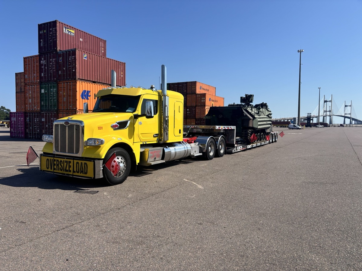 Peterbilt heavy haul truck loaded with military tank at port